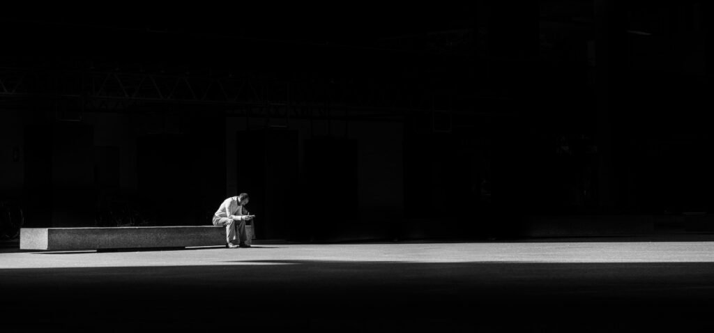 men is sitting alone and thinking